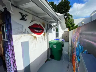 a wall with a mural of alip on it at Unique Miami Art Escape w/ HotTub, Arcade & Murals in Miami