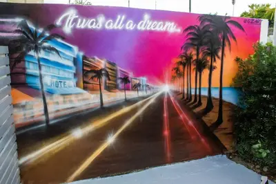 a painting of a street with palm trees on a wall at Cozy & Colorful Miami Art Canvas w/HotTub & Murals in Miami