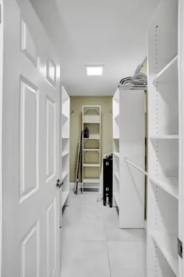 a walk in closet with white doors and shelves at Sensational 5BR Villa Heated Pool near Hard Rock in Hollywood