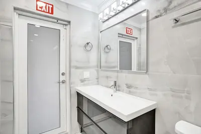 a white bathroom with a sink and a mirror at Sensational 5BR Villa Heated Pool near Hard Rock in Hollywood