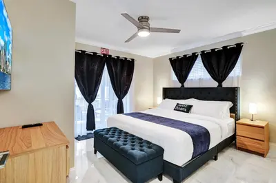 a bedroom with a large bed and a couch at Sensational 5BR Villa Heated Pool near Hard Rock in Hollywood
