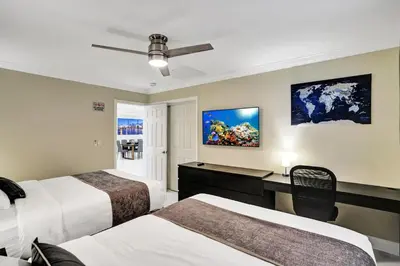 a hotel room with two beds and a desk at Sensational 5BR Villa Heated Pool near Hard Rock in Hollywood