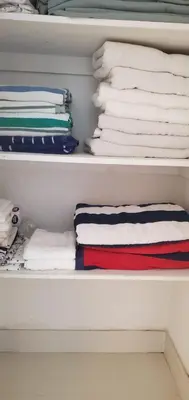 a closet with folded towels and towels at SIAN private Apartments in Hollywood