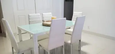 a white table and chairs with a candle on it at SIAN private Apartments in Hollywood