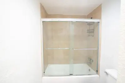 a shower with a glass door in a bathroom at SIAN private Apartments in Hollywood