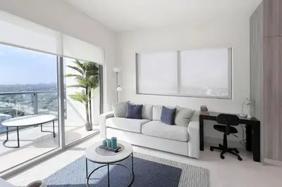 a living room with a white couch and a large window at New 1/1 Apartment in Smart Brickell with Parking in Miami