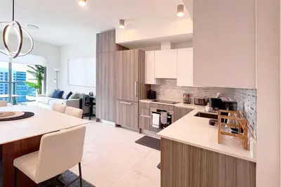 a kitchen with white cabinets and a counter top at New 1/1 Apartment in Smart Brickell with Parking in Miami