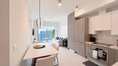 a kitchen with a table and a dining room at New 1/1 Apartment in Smart Brickell with Parking in Miami