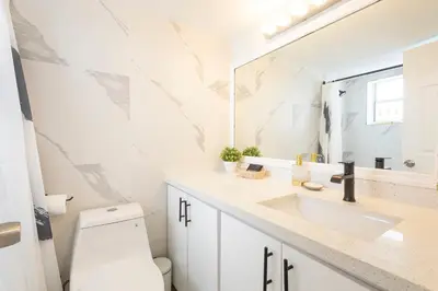 a bathroom with a toilet and a sink and a mirror at Vista Mar: Bay Views Close to Miami Attractions in Miami Beach
