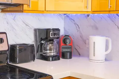 a kitchen counter with a coffee maker and a coffeemaker at Vista Mar: Bay Views Close to Miami Attractions in Miami Beach