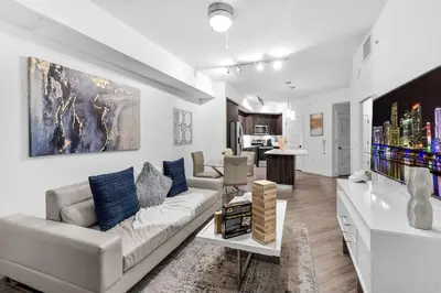 a living room with a couch and a table at Modern 1 Bed in Downtown Doral With Free Parking in Hialeah Gardens