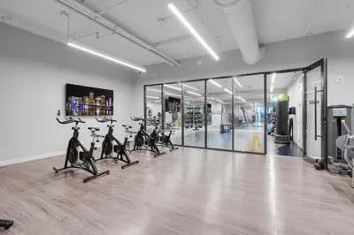 a gym with treadmills and exercise bikes in a room at Modern 1 Bed in Downtown Doral With Free Parking in Hialeah Gardens