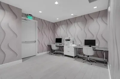 an office with two desks and two computers on the wall at Modern 1 Bed in Downtown Doral With Free Parking in Hialeah Gardens