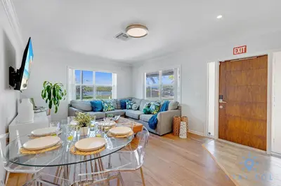 a living room with a table and a couch at Beach Paradise, Family - Friendly, Free Parking in Hollywood