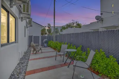 a patio with chairs and a table and a fence at Studio Right off Las Olas - Steps to FTL Beach 1C in Fort Lauderdale