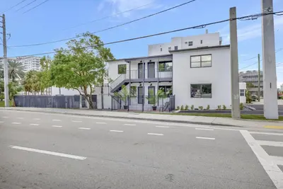 an empty street in front of a white building at Condo Right off Las Olas Steps to FTL Beach 1A in Fort Lauderdale