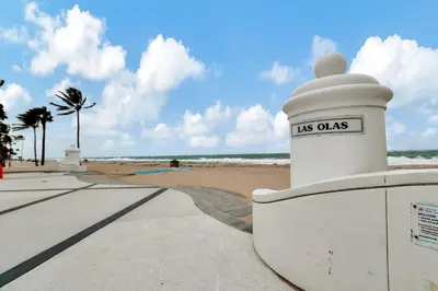 a sign that reads us oaks next to the beach at 2 Condo Combo - Walk to Beach Off Las Olas 1AB in Fort Lauderdale