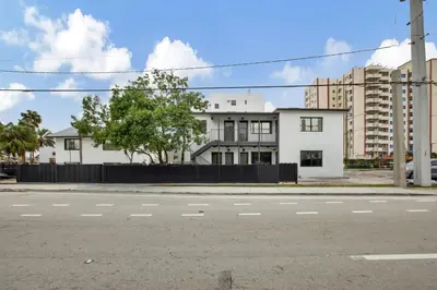 an empty street in front of a white building at Studio Right off Las Olas - Steps to FTL Beach 2C in Fort Lauderdale