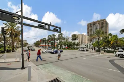 a group of people crossing the street at an intersection at Studio Right off Las Olas - Steps to FTL Beach 2C in Fort Lauderdale
