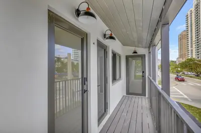 a balcony with a door and a view of a street at Studio Right off Las Olas - Steps to FTL Beach 1B in Fort Lauderdale
