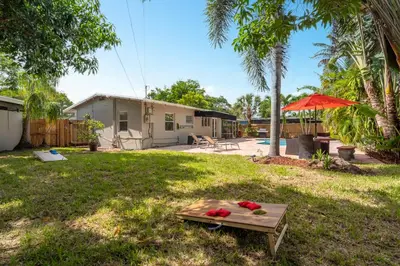 a backyard with a table with flowers on it at Wills off Wilton Drive 2 bed and 1 bath plus Den with Heated Pool in Fort Lauderdale
