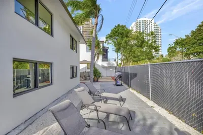 a row of chairs on a patio with a fence at Lux Villa 3br 2ba off Las Olas in Fort Lauderdale