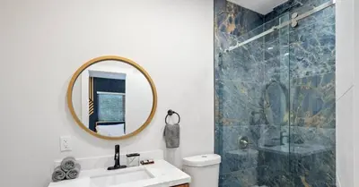 a bathroom with a sink and a mirror and a shower at Sunny Isles Beach Luxury Property by Glam Homes in Miami