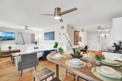a dining room and living room with a table at Beach Condo - Hollywood Beachfront and Broadwalk in Hollywood