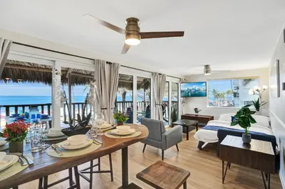 a bedroom with a bed and a dining room with a table at Beach Condo - Hollywood Beachfront and Broadwalk in Hollywood