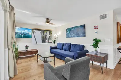 a living room with a blue couch and chairs at Beach Condo - Hollywood Beachfront and Broadwalk in Hollywood