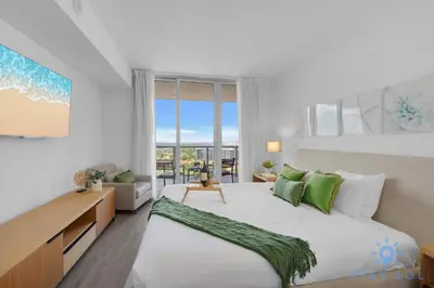 a bedroom with two beds and a large window at Condo Retreat with Stunning Views and Amazing Pools in Hallandale Beach