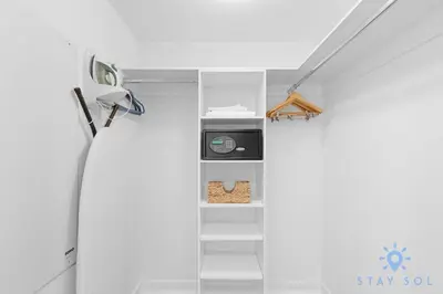 a room with a shelf with a clock on it at Condo Retreat with Stunning Views and Amazing Pools in Hallandale Beach
