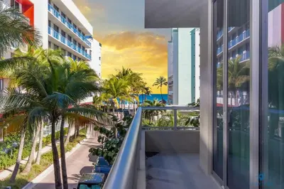 a view from the balcony of a building with palm trees at Amazing Pool - Hot Tub - Gym - Near Beach in Hollywood
