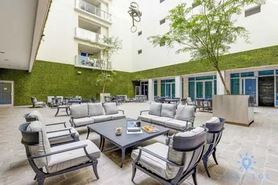 a patio with couches and chairs and a table at Amazing Pool - Hot Tub - Gym - Near Beach in Hollywood