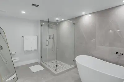 a bathroom with a shower and a bath tub at Shades of Miami Sky Penthouse! Newly Renovated in Miami