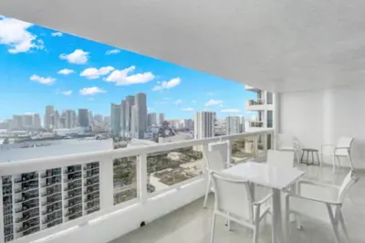 a balcony with a table and chairs and a view of the city at Shades of Miami Sky Penthouse! Newly Renovated in Miami