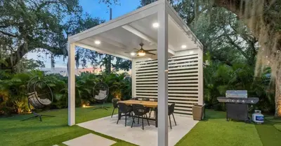 a pavilion with a table and a grill in a yard at Entertaining Villa Fun Games Mini Golf Grill in Miami