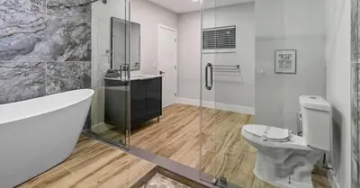a bathroom with a tub and a toilet and a shower at Entertaining Villa Fun Games Mini Golf Grill in Miami