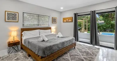 a bedroom with a bed and a large window at Entertaining Villa Fun Games Mini Golf Grill in Miami