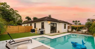 a house with a swimming pool in the yard at Tropical Villa wJacuzzi Big Terrace & Billiards in Miami