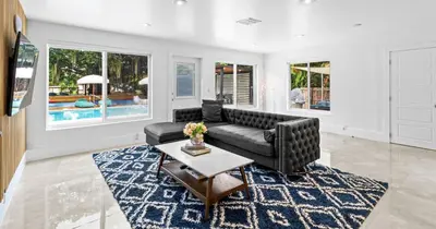 a living room with a black couch and a table at New Hidden Gem in Miami