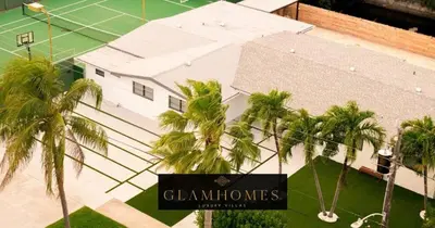 an overhead view of a building with palm trees at Luxurious Retreat with Tennis and Soccer Courts TGH in Miami