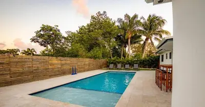 a swimming pool in the backyard of a house at Luxurious Retreat with Tennis and Soccer Courts TGH in Miami