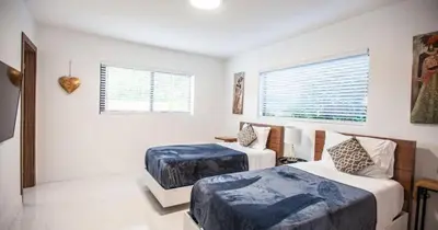 a bedroom with two beds and a window at Luxurious Retreat with Tennis and Soccer Courts TGH in Miami