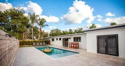 a swimming pool in the backyard of a house at Luxurious Retreat with Tennis and Soccer Courts TGH in Miami
