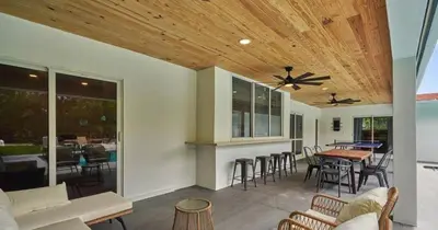 a living room with a ceiling fan and a table and chairs at Villa Athena - The Glamhomes in Miami