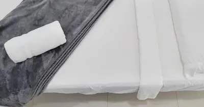 a piece of paper sitting on top of a bed at Villa Athena - The Glamhomes in Miami