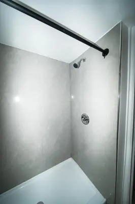 a bathroom with a shower with a glass door at Sinbad Motel in Miami