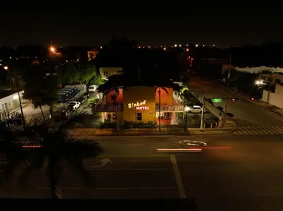 a building on the side of a street at night at Sinbad Motel in Miami