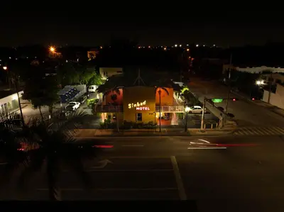 a building on the side of a street at night at Sinbad Motel in Miami